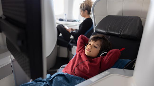 A very well behaved and relaxed looking child in business class.