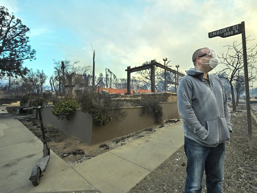 AFTER: Jason Blundell surveys his neighborhood as he stands next to his burned home on Embury St in the Pacific Palisades. Picture: MediaNews Group via Getty Images