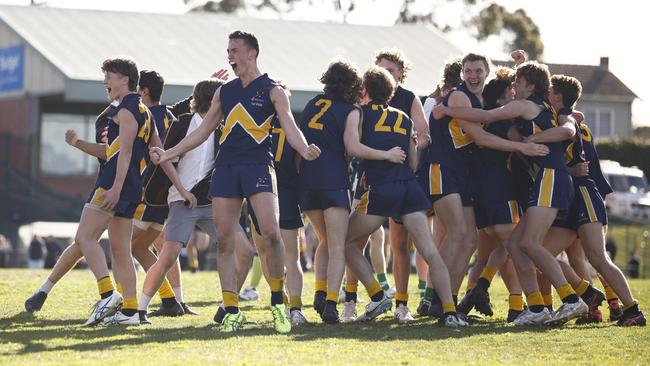 Lochie Reidy of Whitefriars College (4L) and teammates celebrate on the final siren after winning the Herald Sun Shield Senior Boys Grand Final. Picture: Daniel Pockett/AFL Photos/via Getty Images