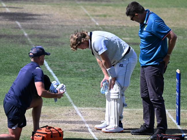 Will Pucovski is checked by medical staff after being struck by a delivery from Riley Meredith during the Sheffield Shield match on March 3 in Hobart. Picture: Steve Bell/Getty Images.