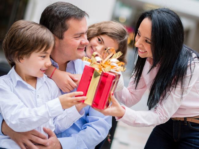 Family celebrating father's day and holding a present Picture: iStock