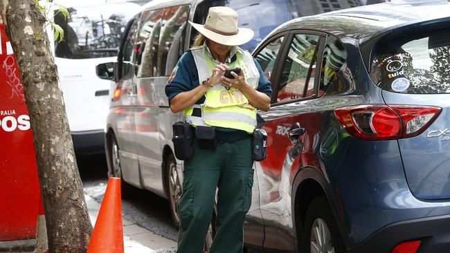 A City of Sydney parking ranger at work on Liverpool St. Picture: John Appleyard