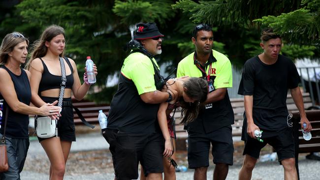 A girl is helped by security staff to paramedics outside the Rolling Loud Festival at Sydney’s Olympic Park on Sunday. Picture: Damian Shaw