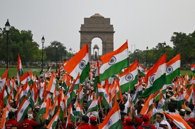 People waving Indian  flags take part in a rally in New Delhi expressing solidarity with the armed forces