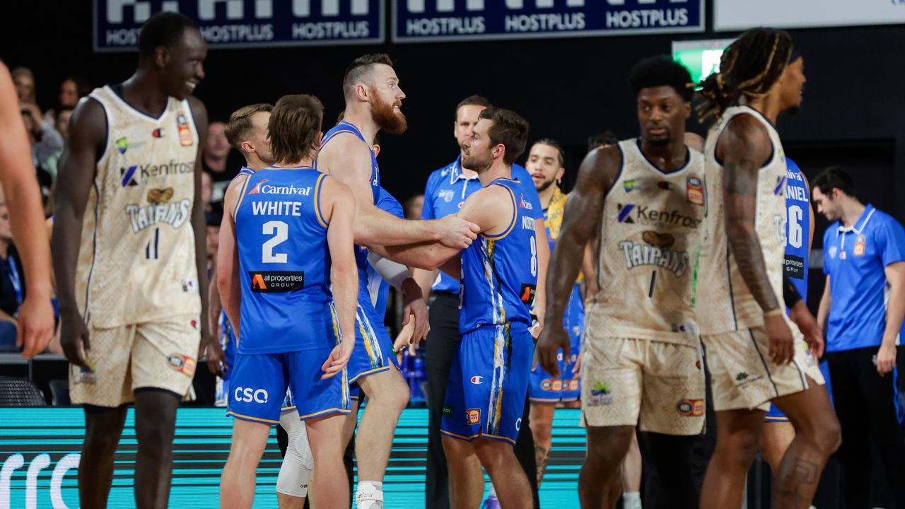 Aron Baynes is held back by Bullets teammates after exchanging words with officials during their last clash with the Taipans in October. Picture: Getty