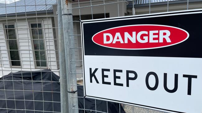 Signs from evacuated homes at Riverstone Crossing at Maudsland after a landslip.