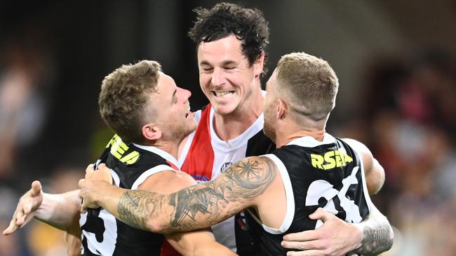 BRISBANE, AUSTRALIA - OCTOBER 03: Jack Lonie, Jake Carlisle and Jack Sinclair of the Saints celebrate after the Saints defeated the Bulldogs during the AFL Second Elimination Final match between the St Kilda Saints and the Western Bulldogs at The Gabba on October 03, 2020 in Brisbane, Australia.  (Photo by Quinn Rooney/Getty Images)