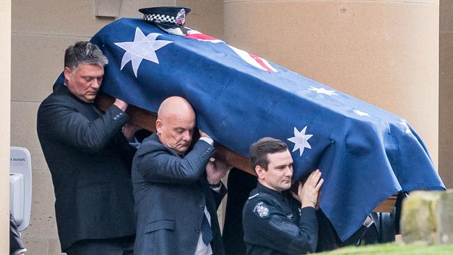 Josh's brother Alex helps carry the coffin from the chapel. Picture: Jake Nowakowski