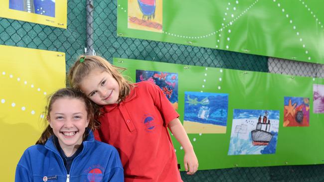 The Postcards to Port project, on the Spirit of Tasmania ferry terminal fence at Station Pier, consists of a series of postcards created by Port Melbourne Primary School, including co-captains Ruby, 11, and Tess, 5.