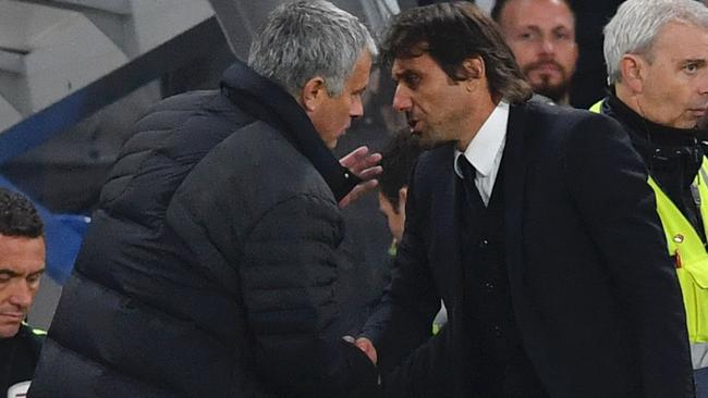 Chelsea's Italian head coach Antonio Conte (R) shakes hands with Jose Mourinho.