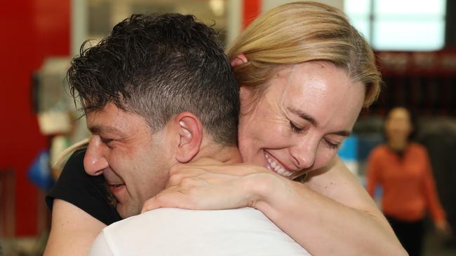 Adam de Guara embraces his partner Genevieve Wild after being apart for 5 months. Picture: NCA NewsWire / Damian Shaw