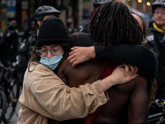 So-called demonstrators embrace as the CHOP is finally torn down. Picture: AFP