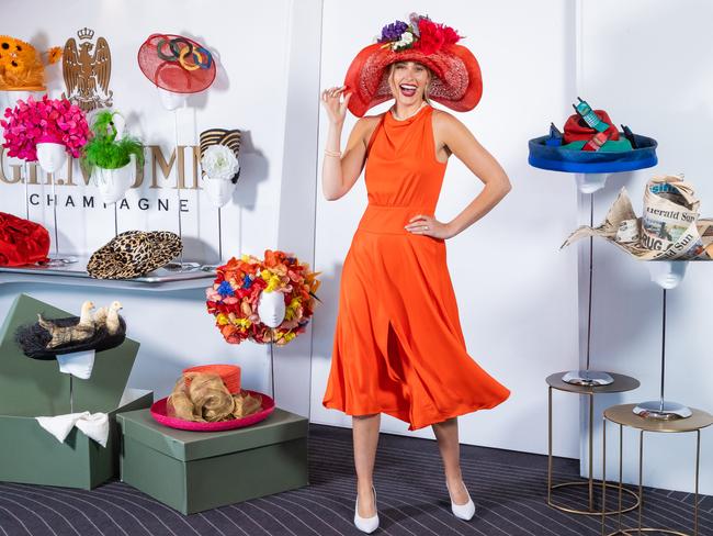 Flanked by Lillian Frank’s extensive hat collection, Emily Nash wears a hat by milliner Melissa Jackson, recreated from Lilian’s 1988 Oaks Day outfit. Picture: Jason Edwards