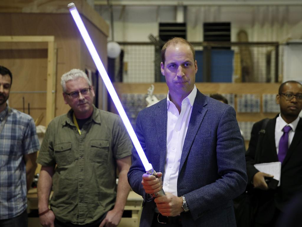 Prince William, Duke of Cambridge holds a lightsaber during a tour of the Star Wars sets at Pinewood studios on April 19, 2016 in Iver Heath, England. Picture: Getty