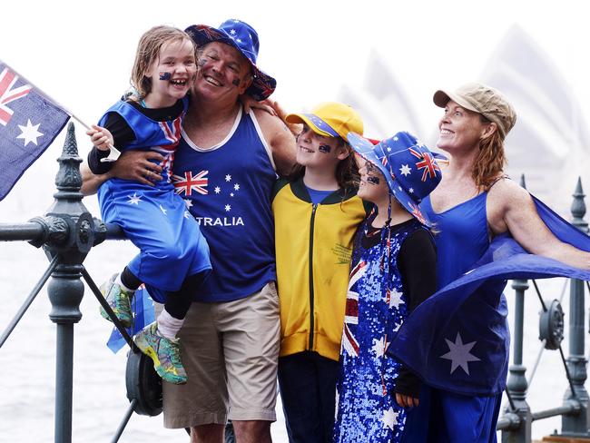 The McGregor family — Myah, Grant, Shae, Tara and Kirstin (right) — braving the wet weather one year as they celebrated Australia Day under the Harbour Bridge, Bradfield Park.