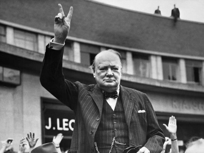 Sir Winston Churchill flashing the V-sign for victory in 1950.