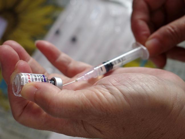 A health worker prepares a dose of Pfizer COVID-19 coronavirus vaccine. (Photo by BAY ISMOYO / AFP)