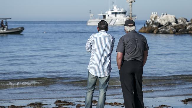 Indian Pacific School Games spokesman Surender Chahal, left, at the Glenelg breakwater where the body of Nitisha Negi was retrieved on Monday. Picture: AAP/Mike Burton