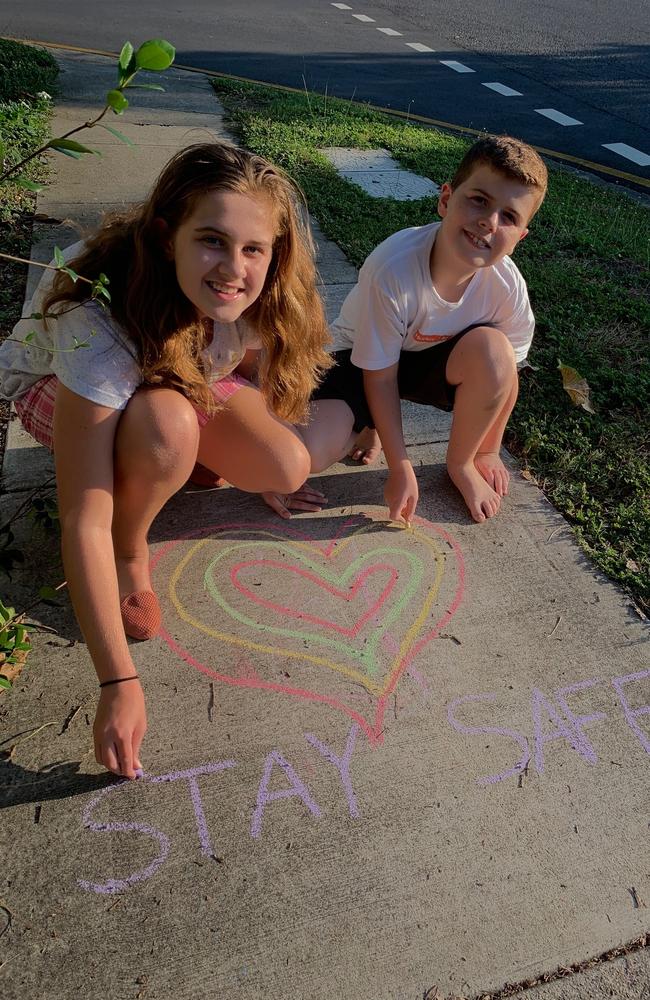 Abby Argus, 11, and brother Patrick, 9, put the finishing touches to their footpath art at Nundah.