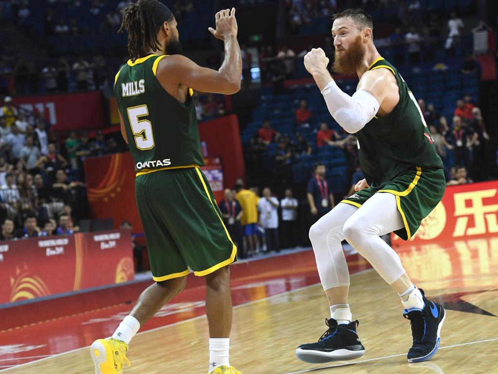 Aron Baynes and teammate Patty Mills celebrate after Australia’s team's win against France at the 2019 Basketball World Cup in China. Photo: AFP.