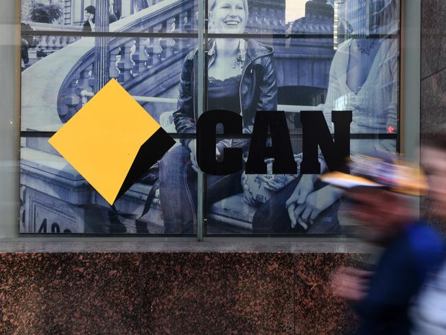 CBD workers walk past the a Commonwealth Bank of Australia branch in Sydney, Monday, June 4, 2018. The CBA has a reached a $700 million dollar settlement over Austrac allegations over anti-money laundering breaches. (AAP Image/Dean Lewins) NO ARCHIVING