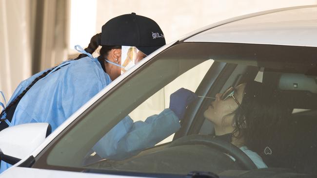 A woman undergoes a Covid test at a drive-through clinic. Picture: NCA NewsWire / Dan Peled