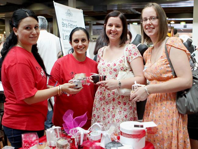 Natasha Kalmadjian (L) and Jackie Badelian from Artisters Design show bonbonniere gifts to Kylie Reynolds and Erin Norman (R).