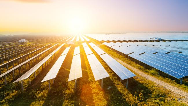 Photovoltaic modules reflect sunset light and clouds