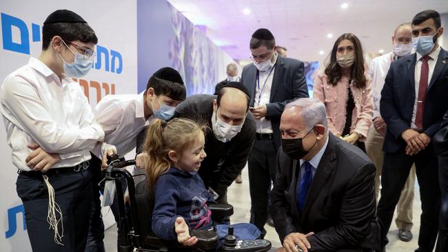 Benjamin Netanyahu drops into a COVID-19 vaccination centre in Jerusalem this week. Picture: AFP