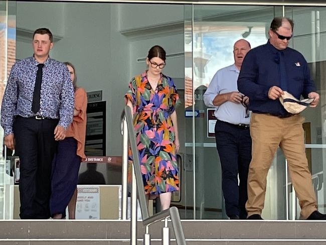 Jak Alan Kuhn (far left with dark tie) and Aaron Frederick Harold Kuhn (on the right in a navy shirt and tan pants) leaving Rockhampton courthouse during a trial where they have been accused of assault Craig Douglas Chicken with a baseball bat, chain and fists.