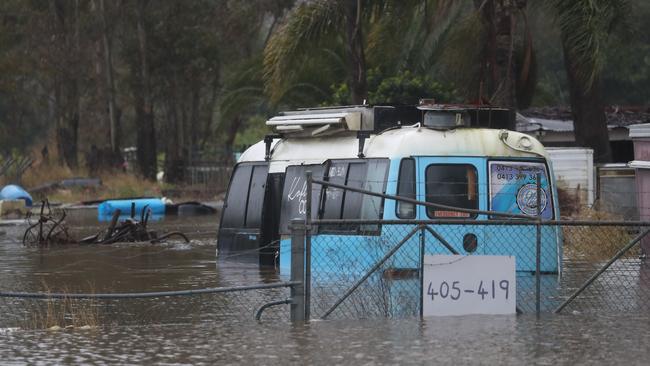 Shops and a mini bus in Vineyard are all underwater. Picture: John Grainger