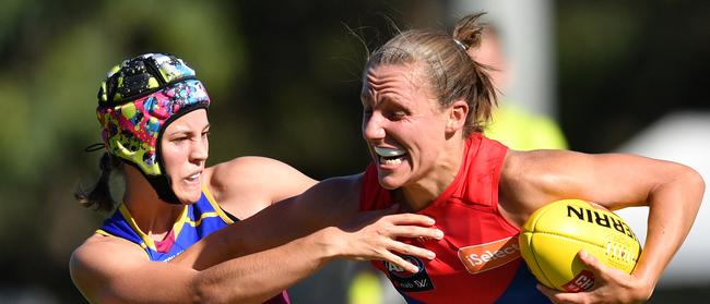 Karen Paxman (right) of the Demons is tackled by Tori Groves-Little (left).                  (AAP Image/Darren England) 