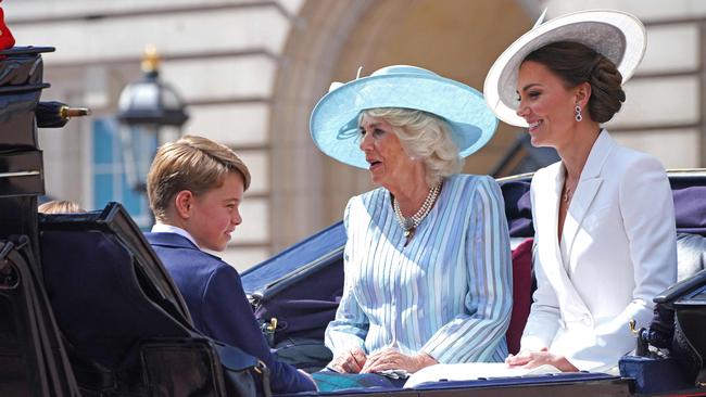 Prince George of Cambridge, left, Camilla, Duchess of Cornwall and Catherine, Duchess of Cambridge. leave Buckingham Palace in London on Thursday night. Picture: AFP