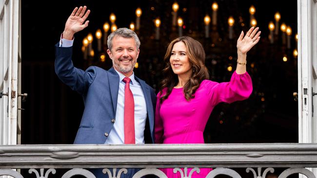 King Frederik and Queen Mary wave from the balcony. Picture: AFP
