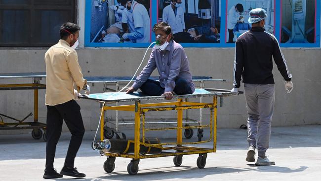 A COVID-19 patient is shifted to a ward at the GTB hospital in New Delhi. Picture: AFP