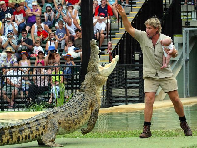 Outcry … pictures of Steve Irwin holding his newborn son while feeding a crocodile resulted in the withdrawal of his Australian of the Year award, as revealed in Lisa Curry’s book. Picture: The Mega Agency