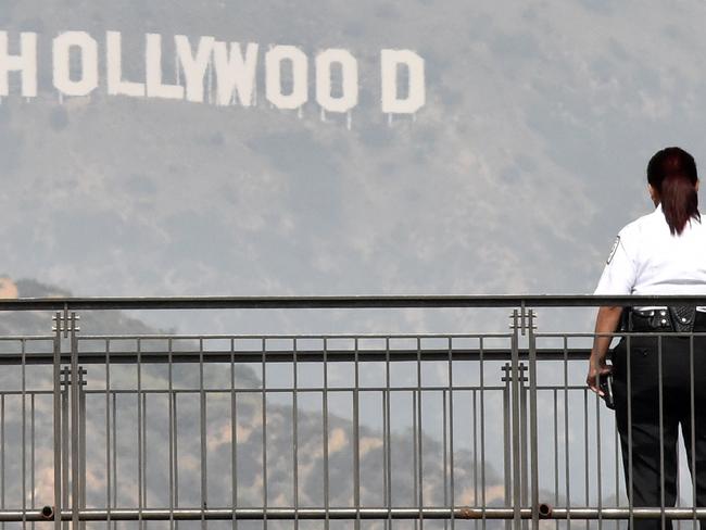 A security guard stands guarding on a shopping mall terrace outside Dolby Theatre as preparations are underway for the 87th annual Academy Awards in Hollywood, California on February 20, 2015. The 87th Oscars takes place on February 22 at Hollywood's Dolby Theatre. AFP PHOTO/MLADEN ANTONOV