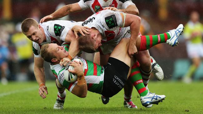 South Sydney's Jason Clark is tackled by the Dragons at the SCG. Picture: Brett Costello