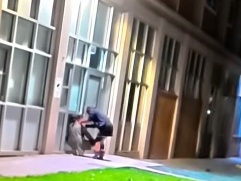 A woman injects heroin into the neck of a drug user outside the commission flats. Picture: YouTube