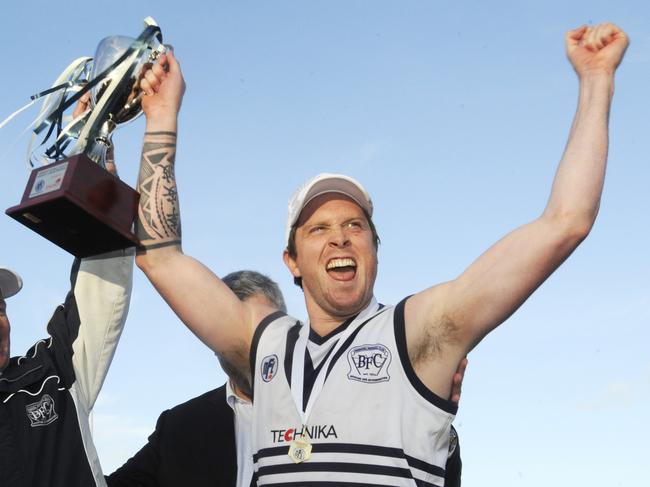 Brayden Shaw raises the 2011 premiership cup. 