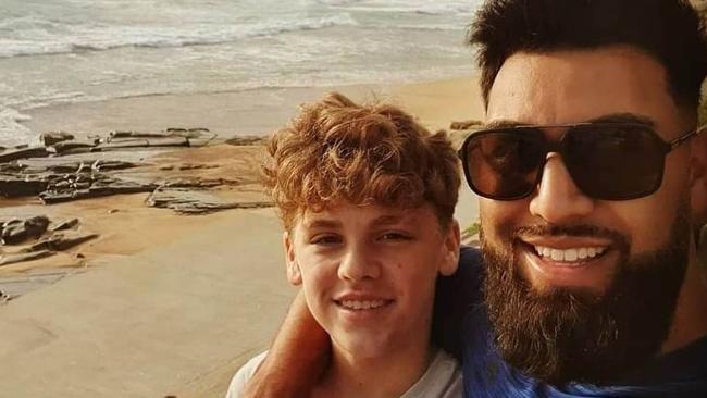 Scott Peters with his son Usher-Takai Peters at the beach in Newcastle.