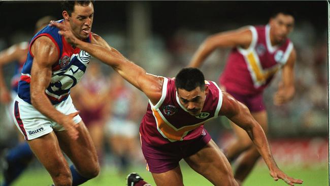 Brisbane Bears footballer Danny Dickfos holds off Footscray's Nigel Kellet. He was an Eagles junior.