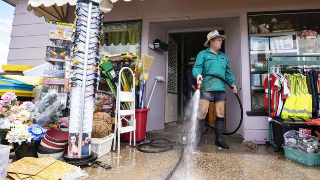 Volunteers in Inglewood helping clean out a pharmacy impacted by this week’s flood. Picture: Lachie Millard