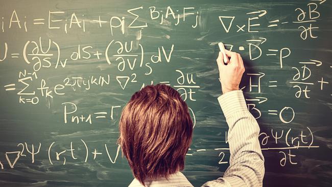 Newton's Equations. Rear view, close-up on young man standing back against green chalkboard. He explains, solves physics tasks, retro style. Processing for retro bleached look, slight vignette added.