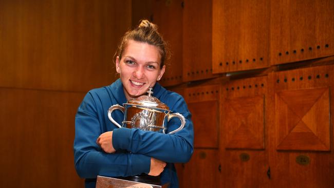 Simona Halep cuddles the trophy after winning the 2018 women’s singles final at the French Open. Picture: AFP/French Tennis Federation/Corinne Dubreuil