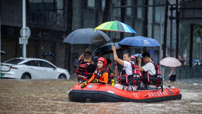 TOPSHOT - Rescue workers ride a boat along a flooded street in Shenzhen, in China's Guangdong province on September 8, 2023, after the city recorded the heaviest rains since records began in 1952. (Photo by AFP) / China OUT