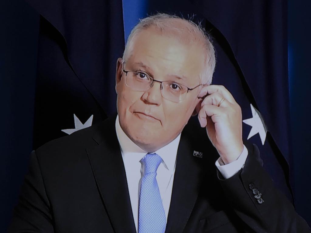 Scott Morrison fixes his ear piece. Picture: NCA NewsWire / Gary Ramage