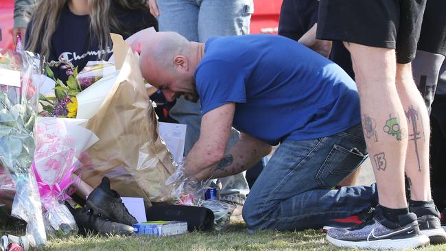 The heartbroken father put his sons trainers underneath a tree at the crash site. Picture: John Feder/The Australian.