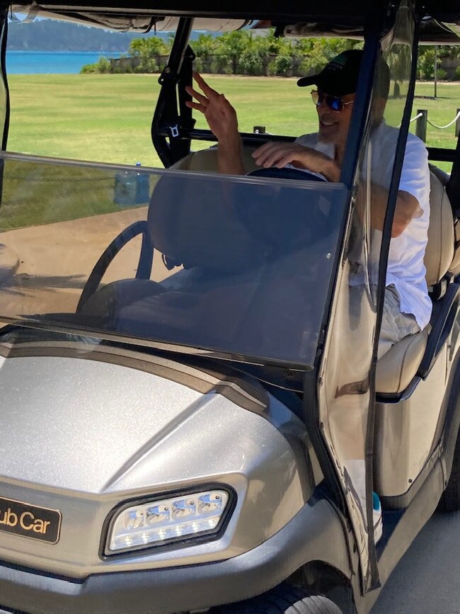 George Clooney takes a ride in one of Hamilton Island's trademark golf buddies.