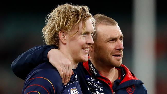 MELBOURNE, AUSTRALIA - SEPTEMBER 09: Clayton Oliver of the Demons and Simon Goodwin, Senior Coach of the Demons are seen during the 2022 AFL Second Semi Final match between the Melbourne Demons and the Brisbane Lions at the Melbourne Cricket Ground on September 9, 2022 in Melbourne, Australia. (Photo by Dylan Burns/AFL Photos via Getty Images)